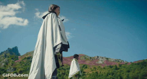 Woman In White Cape Standing In Field GIF