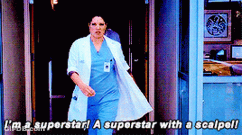 Woman In White Coat And Blue Scrubs Says I'm A Superstar GIF