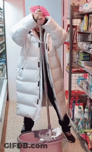 Woman In White Coat Holding Mop In Pink Bucket GIF