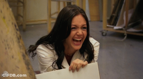 Woman In White Coat Laughing Holding Paper GIF