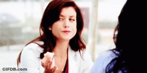 Woman In White Coat Talking To Another Woman Holding Food GIF
