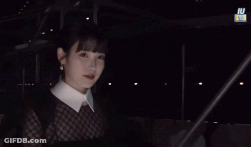 Woman In White Collared Shirt With IU TV Sign GIF