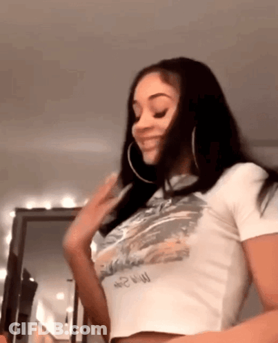 Woman In White Crop Top And Hoop Earrings GIF