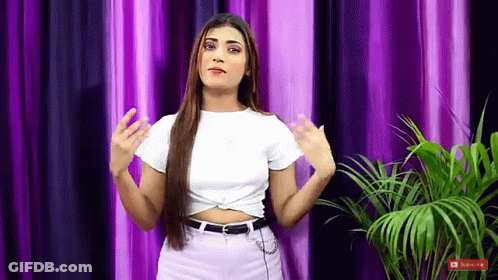 Woman In White Crop Top And Purple Jeans With Curtain And Palm GIF