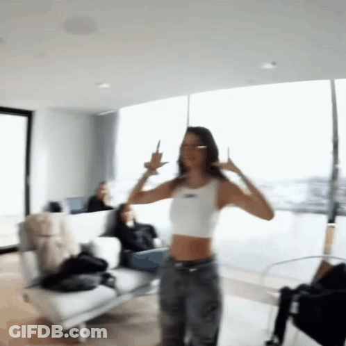 Woman In White Crop Top Dancing And Giving Middle Finger GIF