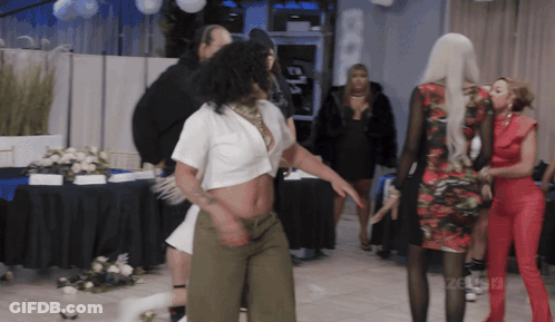 Woman In White Crop Top Dancing In Front Of Celebrity Sign GIF