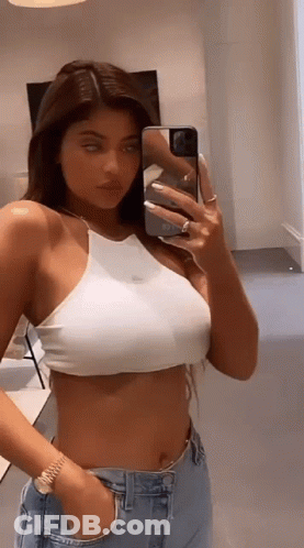 Woman In White Crop Top Taking Selfie In Mirror GIF