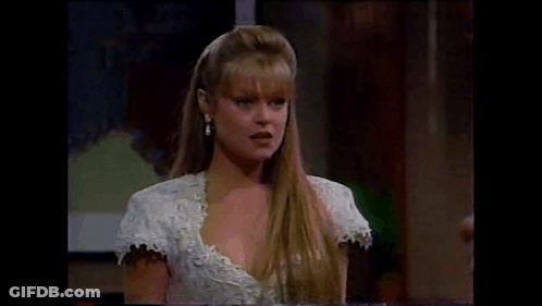 Woman In White Dress And Earrings Sitting At Table GIF