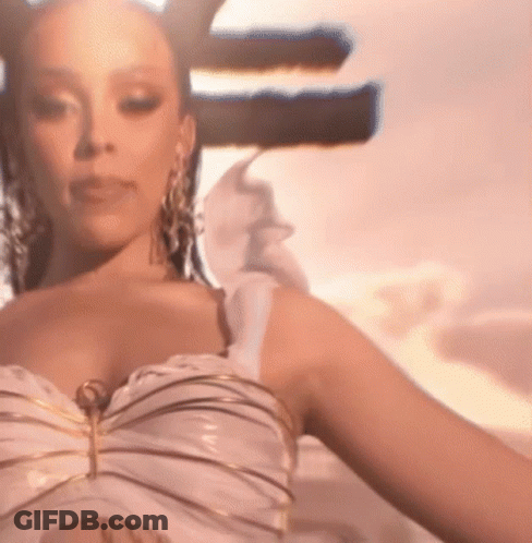 Woman In White Dress And Gold Earrings Standing In Front Of Sign GIF