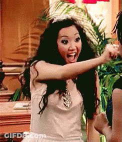 Woman In White Dress And Tiara Pointing At Another Woman GIF