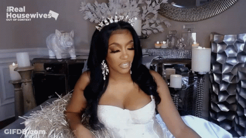 Woman In White Dress And Tiara With Real Housewives Sign GIF