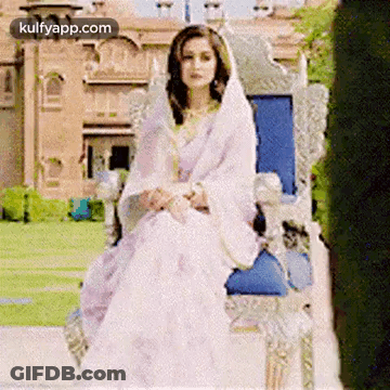 Woman In White Dress And Veil Sitting On Throne GIF