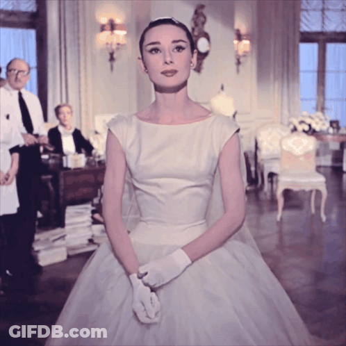 Woman In White Dress And White Gloves Standing In Room GIF