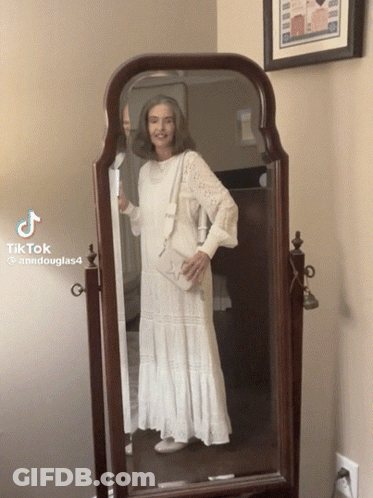 Woman In White Dress At Mirror With TikTok GIF
