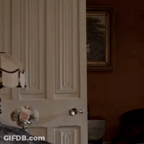 Woman In White Dress Behind Door GIF