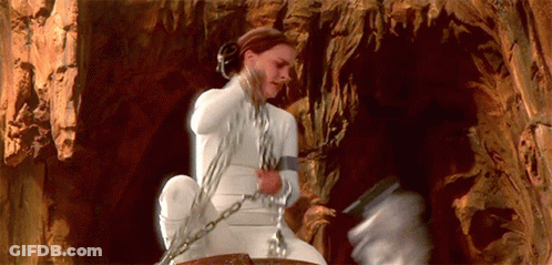 Woman In White Dress Chained To Rock GIF