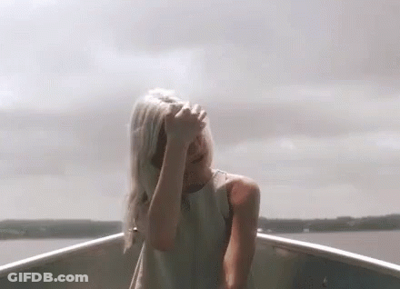 Woman In White Dress Covering Face In Boat GIF