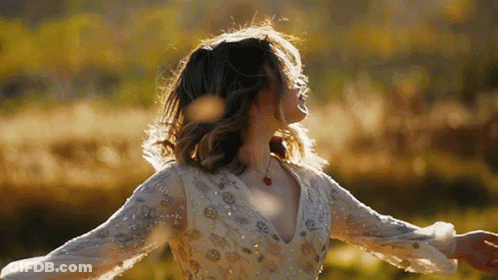 Woman In White Dress Dancing In Field GIF