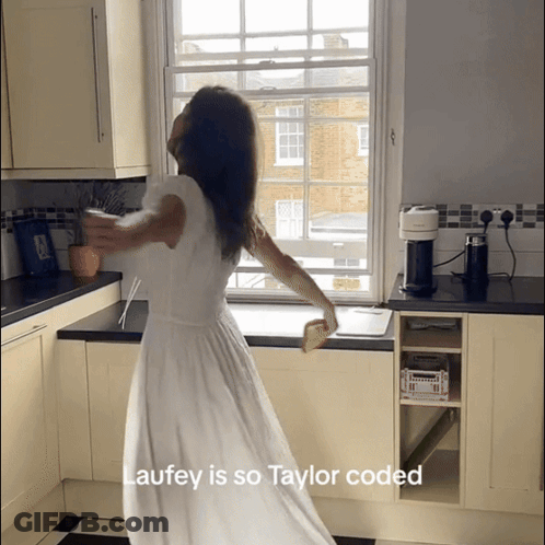 Woman In White Dress Dancing In Kitchen Laufey Is So Taylor Coded GIF