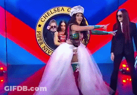 Woman In White Dress Dancing On Red Carpet In Front Of Chelsea Sign GIF