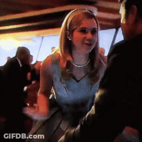 Woman In White Dress Dancing With Man In Black Suit GIF
