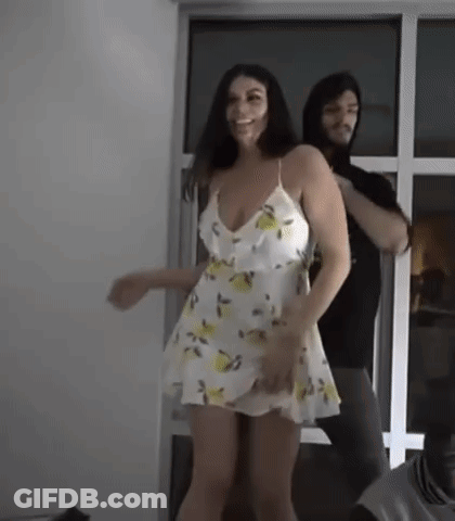 Woman In White Dress Dancing With Man In Hoodie GIF