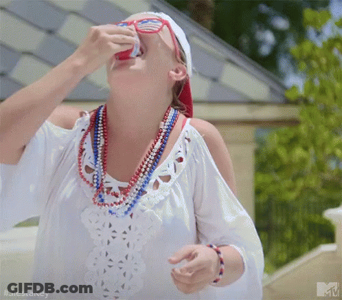 Woman In White Dress Drinking From Can With Red White Blue Beads GIF