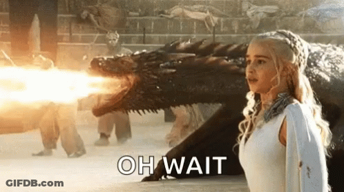 Woman In White Dress Facing Fire-Breathing Dragon GIF