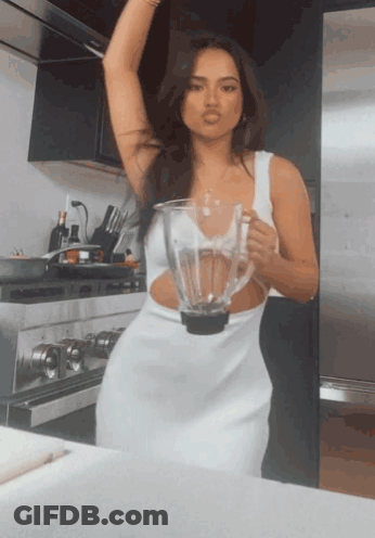Woman In White Dress Holding Blender GIF