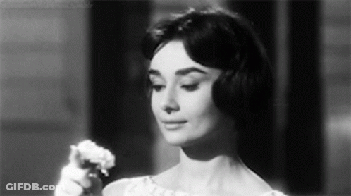 Woman In White Dress Holding Flower Black And White GIF