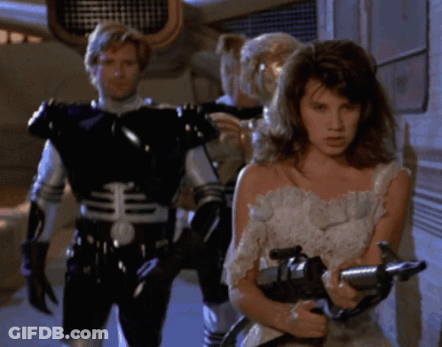 Woman In White Dress Holding Gun GIF