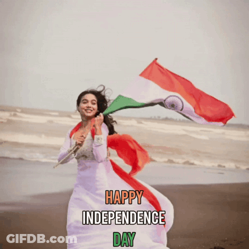 Woman In White Dress Holding Indian Flag On Beach GIF