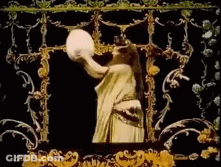 Woman In White Dress Holding Large White Object GIF