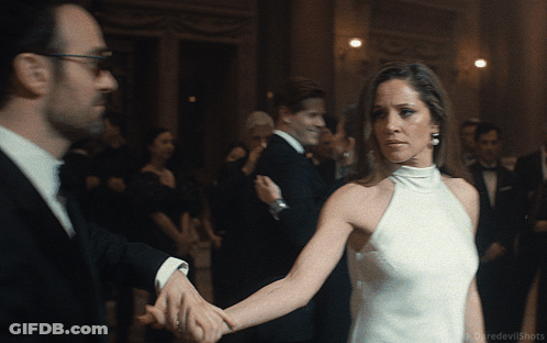 Woman In White Dress Holding Man's Hand GIF
