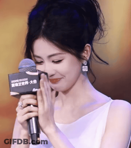 Woman In White Dress Holding Rode Microphone GIF