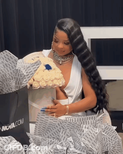 Woman In White Dress Holding Roses And Nova.com Bag GIF