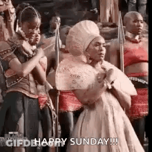 Woman In White Dress Holding Spears Saying Happy Sunday GIF