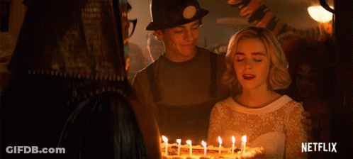 Woman In White Dress In Front Of Cake And Netflix Logo GIF