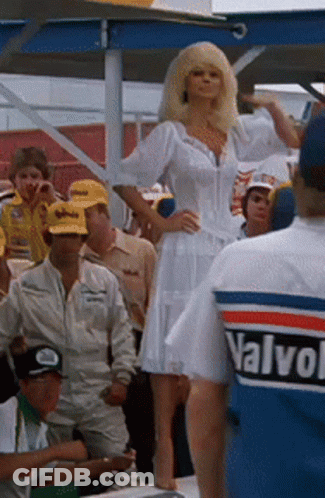 Woman In White Dress In Front Of Crowd Wearing Valvoline Shirt GIF