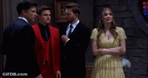 Woman In White Dress In Front Of Man In Suit GIF