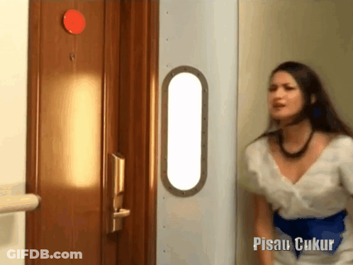 Woman In White Dress In Front Of Pisau Ukur Door GIF