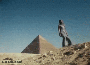 Woman In White Dress In Front Of Pyramid GIF