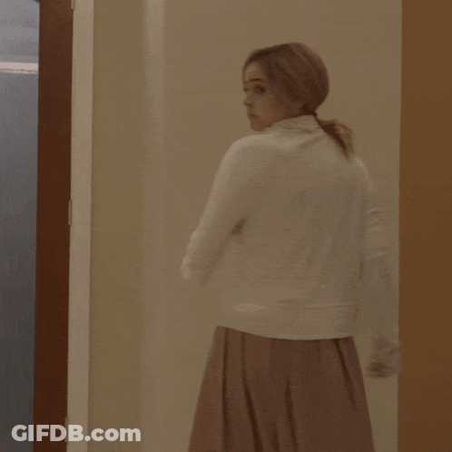 Woman In White Dress In Frosted Glass Doorway GIF