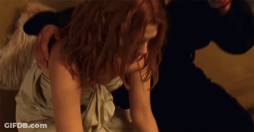 Woman In White Dress Laying On Floor With Man Holding Her Shoulder GIF