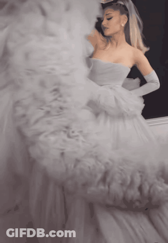 Woman In White Dress Looking In Mirror GIF