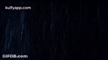 Woman In White Dress Lying In Rain GIF