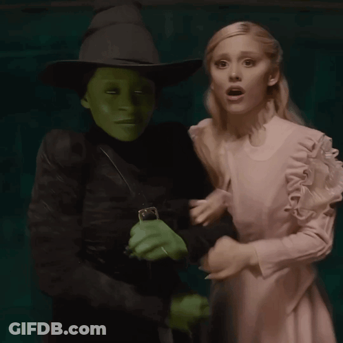 Woman In White Dress Next To Witch GIF