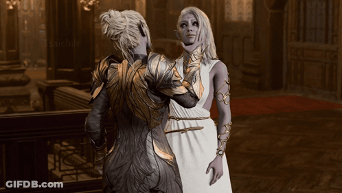 Woman In White Dress Next To Woman In Gold Armor GIF