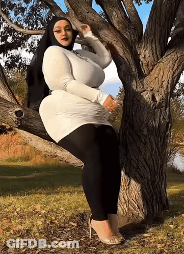 Woman In White Dress On Tree Branch GIF
