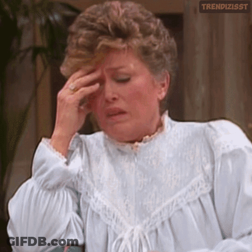 Woman In White Dress Rubbing Forehead GIF